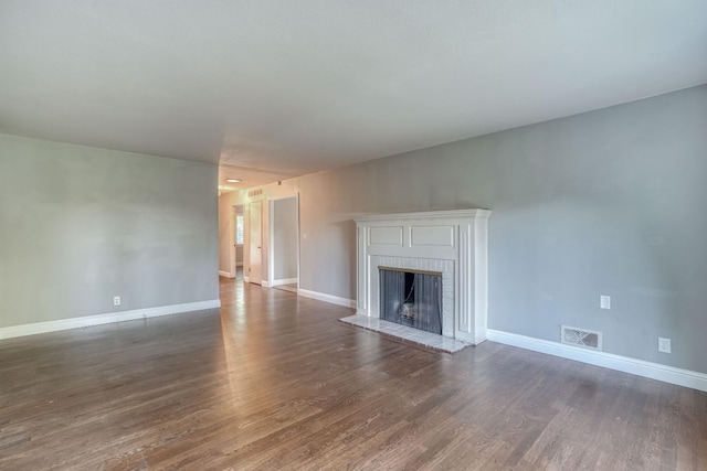 1463 W San Madele Ave, Fresno, CA 93711 - unfurnished living room with dark wood-type flooring, a fireplace, and baseboards