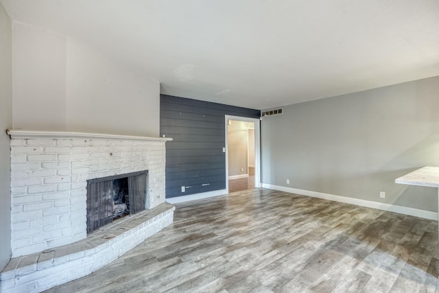 1463 W San Madele Ave, Fresno, CA 93711 - unfurnished living room featuring a fireplace, wood finished floors, and baseboards