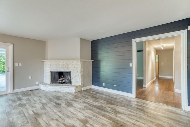1463 W San Madele Ave, Fresno, CA 93711 - unfurnished living room with wood finished floors, a fireplace, and baseboards