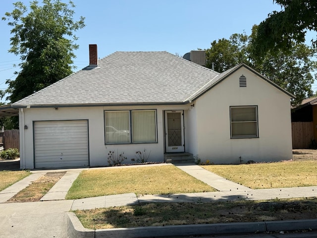 2314 E Cornell Ave, Fresno, CA 93703 - single story home with a shingled roof, a chimney, a garage, stucco siding, and driveway