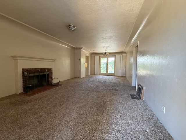 2314 E Cornell Ave, Fresno, CA 93703 - unfurnished living room with a brick fireplace, carpet floors, a textured ceiling, and crown molding