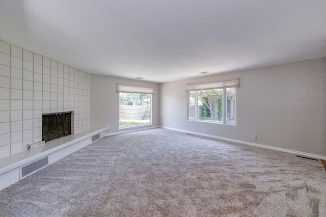 1463 W Browning Ave, Fresno, CA 93711 - unfurnished living room with carpet floors, a tile fireplace, and baseboards