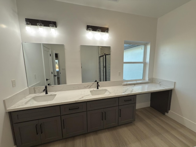21275 Rd 28 Unit 1 2, Madera, CA 93638 - bathroom with wood finished floors, a shower stall, double vanity, and baseboards