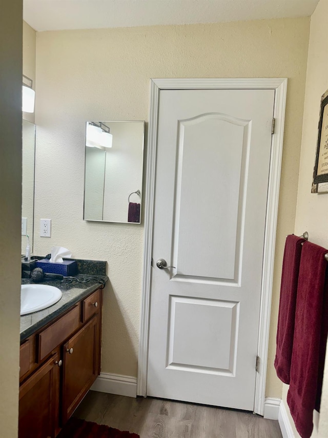 7166 N Fruit Ave Unit 160, Fresno, CA 93711 - bathroom with vanity, wood finished floors, and baseboards