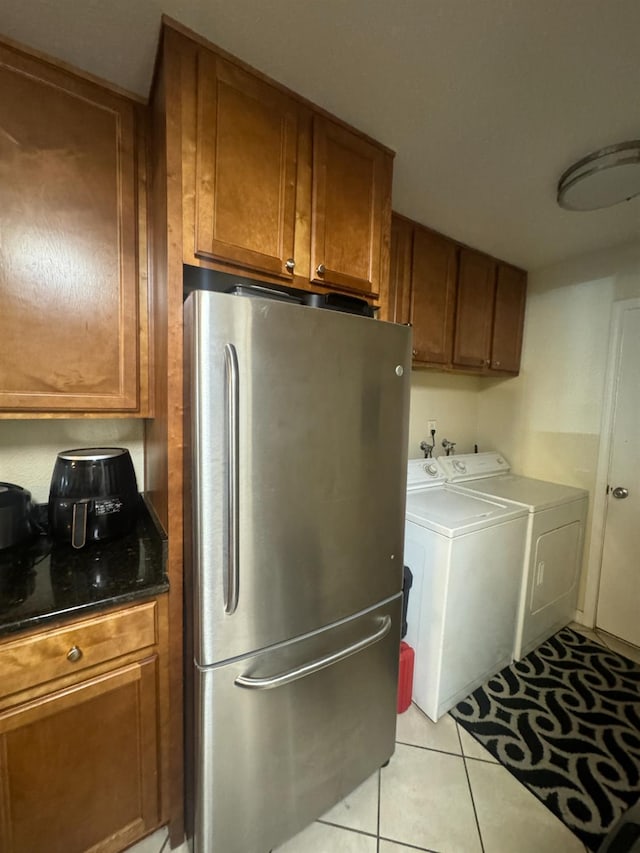 7166 N Fruit Ave Unit 160, Fresno, CA 93711 - kitchen featuring freestanding refrigerator, washing machine and dryer, brown cabinetry, and light tile patterned floors