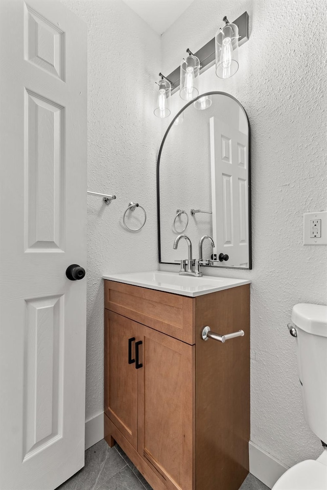 2543 E Ashcroft Ave, Fresno, CA 93726 - bathroom with vanity, toilet, tile patterned floors, and a textured wall