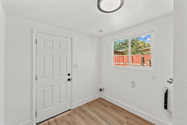 2543 E Ashcroft Ave, Fresno, CA 93726 - laundry area featuring light wood-type flooring and baseboards