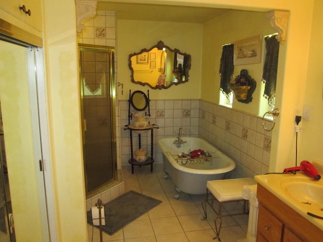 2725 E Normal Ave, Fresno, CA 93703 - full bathroom with tile walls, tile patterned floors, a stall shower, a freestanding tub, and vanity
