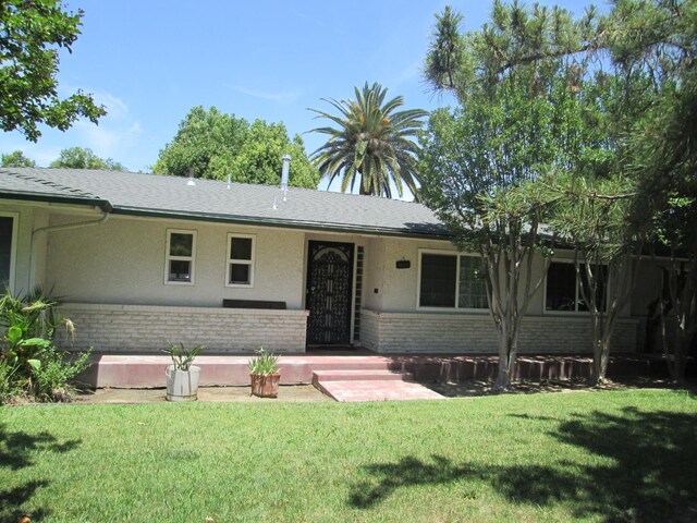 2725 E Normal Ave, Fresno, CA 93703 - ranch-style home with brick siding, a front yard, and stucco siding