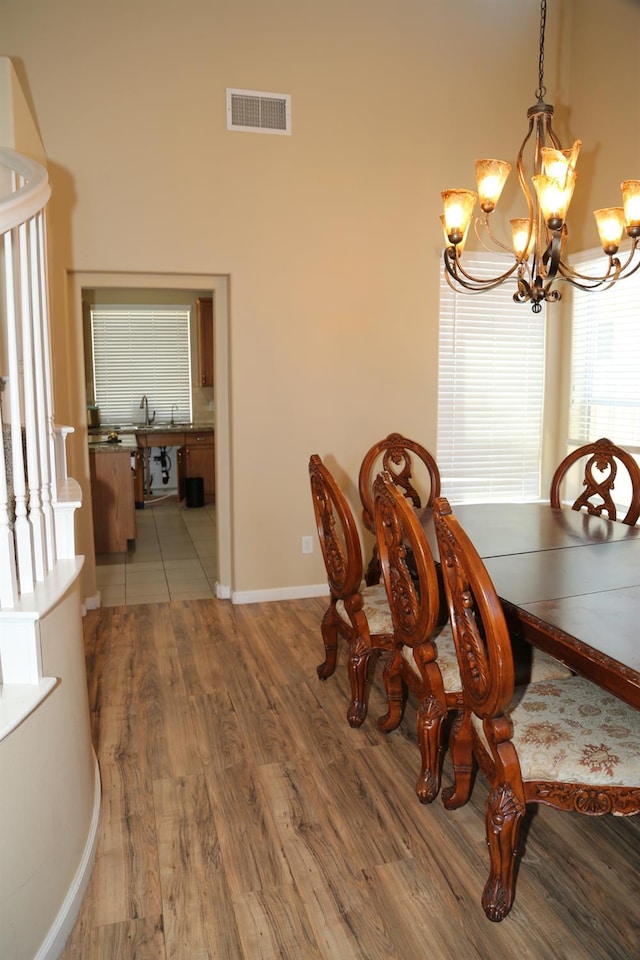 5811 W Cromwell Ave, Fresno, CA 93722 - dining space featuring a chandelier, wood finished floors, and baseboards