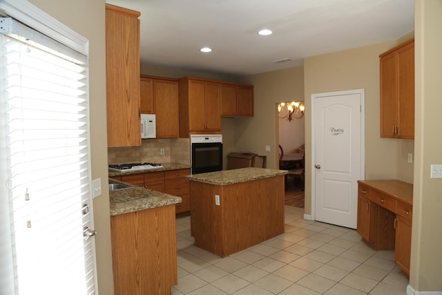 5811 W Cromwell Ave, Fresno, CA 93722 - kitchen featuring white appliances, a center island, a chandelier, decorative backsplash, and light tile patterned floors