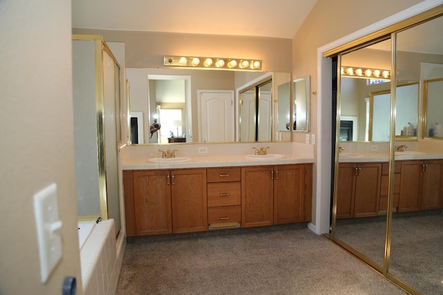 5811 W Cromwell Ave, Fresno, CA 93722 - bathroom with carpet, double vanity, lofted ceiling, and a shower with door