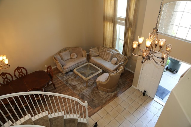5811 W Cromwell Ave, Fresno, CA 93722 - living room featuring a chandelier, light tile patterned flooring, and baseboards