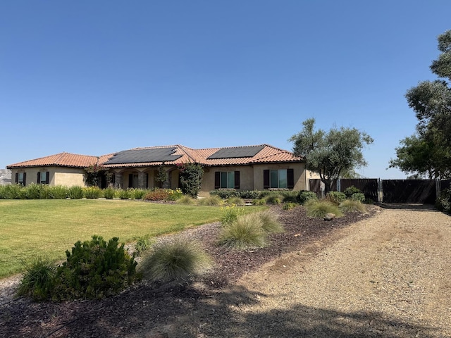 13390 E Falcon Mdw, Clovis, CA 93619 - view of front of home with stucco siding, roof mounted solar panels, and a tile roof