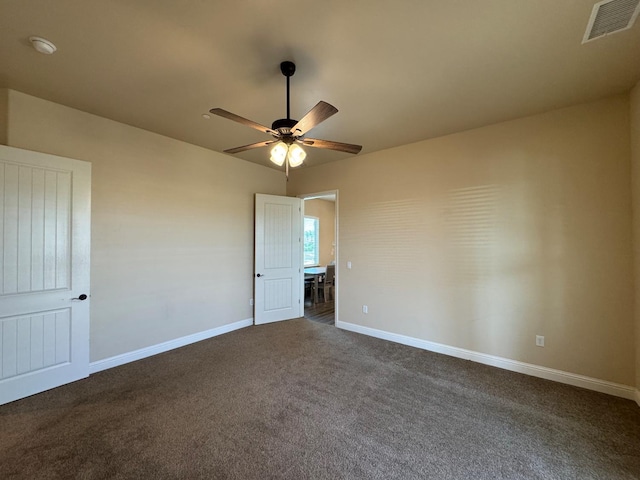 13390 E Falcon Mdw, Clovis, CA 93619 - unfurnished bedroom featuring dark colored carpet, baseboards, and a ceiling fan