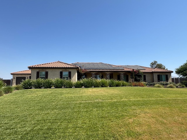 13390 E Falcon Mdw, Clovis, CA 93619 - view of front of home featuring a tiled roof, roof mounted solar panels, stucco siding, and a front lawn
