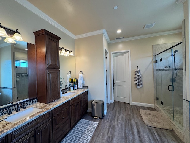 13390 E Falcon Mdw, Clovis, CA 93619 - full bathroom with wood finished floors, double vanity, baseboards, a stall shower, and crown molding