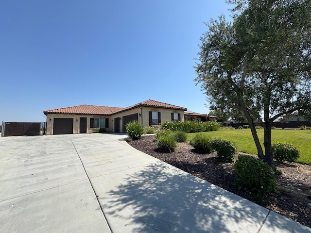13390 E Falcon Mdw, Clovis, CA 93619 - view of front of house featuring an attached garage, a tile roof, a front lawn, stucco siding, and concrete driveway