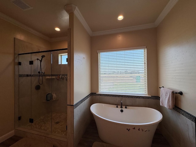 13390 E Falcon Mdw, Clovis, CA 93619 - full bathroom with a freestanding bath, plenty of natural light, a stall shower, wainscoting, and tile walls