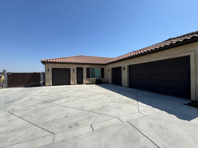 13390 E Falcon Mdw, Clovis, CA 93619 - view of front facade featuring an attached garage, driveway, stucco siding, and a tile roof