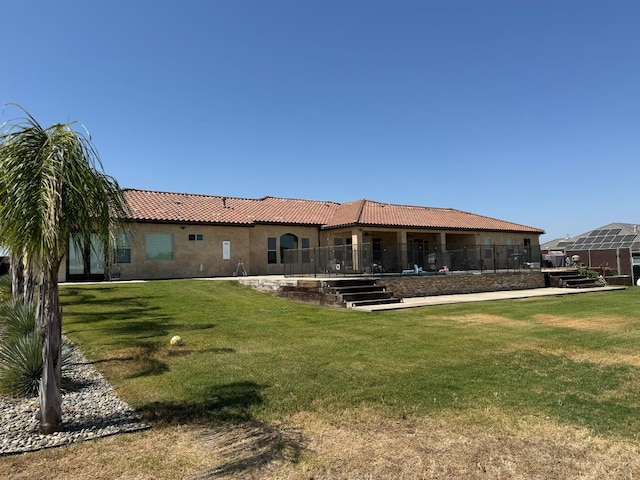 13390 E Falcon Mdw, Clovis, CA 93619 - back of property with a tiled roof, stucco siding, and a lawn