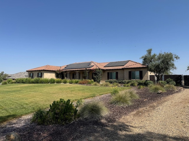 13390 E Falcon Mdw, Clovis, CA 93619 - view of front of home featuring stucco siding, roof mounted solar panels, a tile roof, and a front lawn
