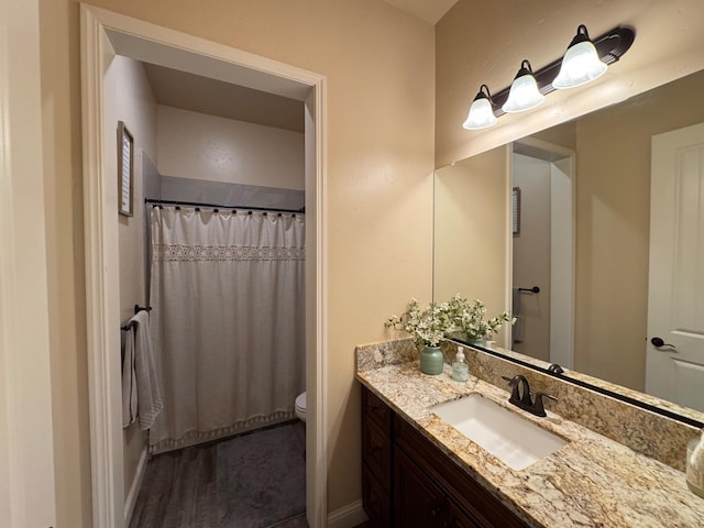 13390 E Falcon Mdw, Clovis, CA 93619 - bathroom featuring toilet, vanity, baseboards, and a shower with curtain