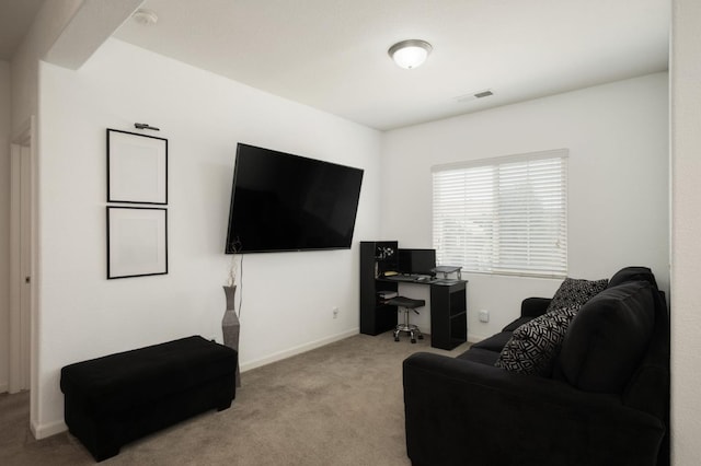 7452 E Giavanna Ave, Fresno, CA 93737 - living room with carpet floors, a desk, and baseboards