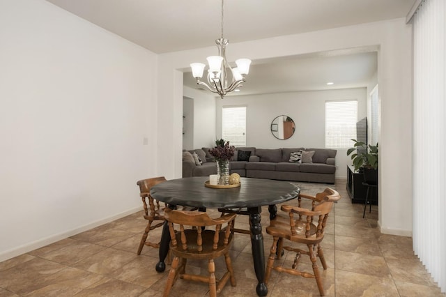 7452 E Giavanna Ave, Fresno, CA 93737 - dining space featuring a chandelier, plenty of natural light, and baseboards