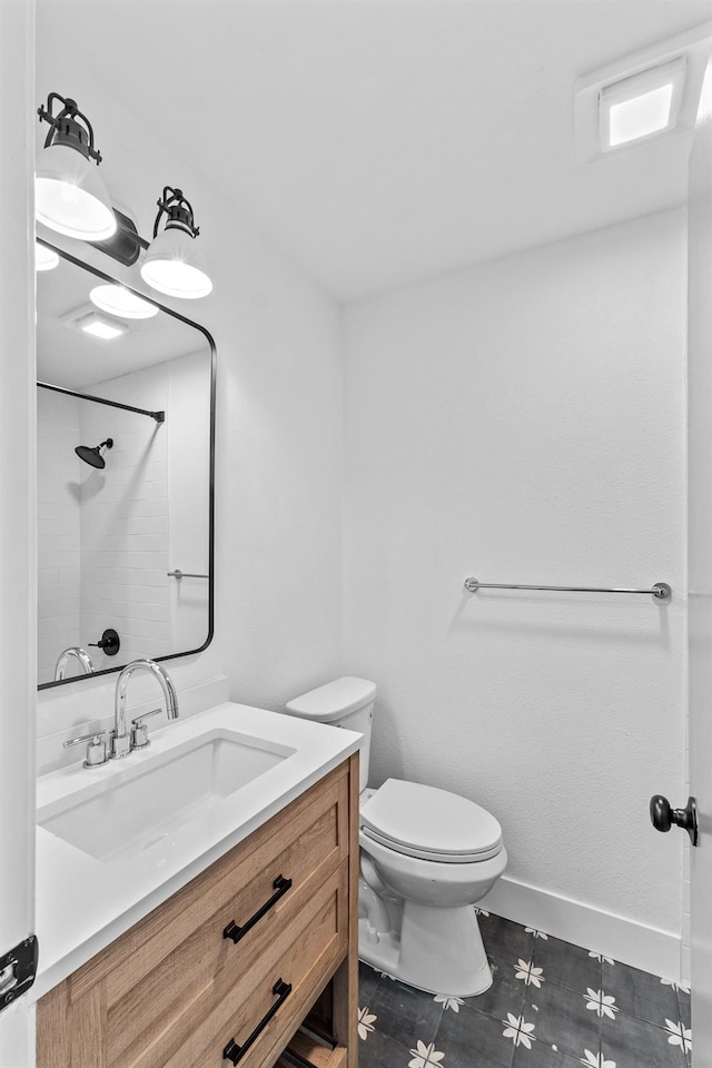 3926 N Kavanagh Ave, Fresno, CA 93705 - bathroom featuring vanity, toilet, a shower, baseboards, and tile patterned flooring