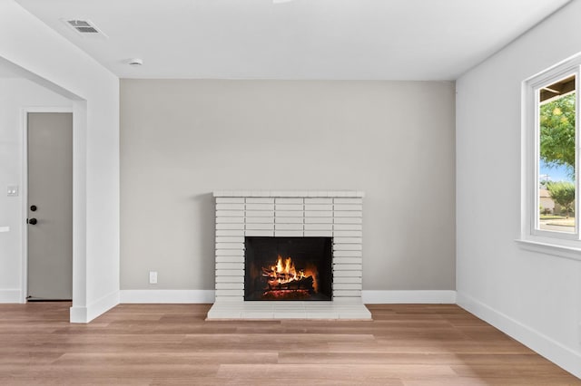 3926 N Kavanagh Ave, Fresno, CA 93705 - detailed view of a brick fireplace, wood finished floors, and baseboards