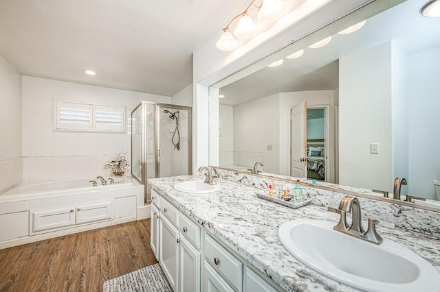 1039 N Burgan Ave, Clovis, CA 93611 - full bath featuring a garden tub, wood finished floors, a shower stall, double vanity, and toilet