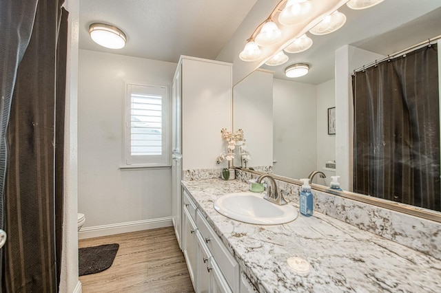 1039 N Burgan Ave, Clovis, CA 93611 - full bath with vanity, wood finished floors, toilet, and baseboards