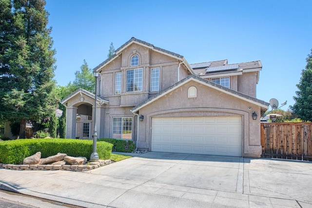 1039 N Burgan Ave, Clovis, CA 93611 - traditional-style home with driveway, stucco siding, solar panels, and an attached garage
