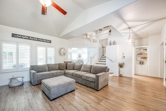 1039 N Burgan Ave, Clovis, CA 93611 - living room with a ceiling fan, stairs, light wood-style flooring, baseboards, and high vaulted ceiling
