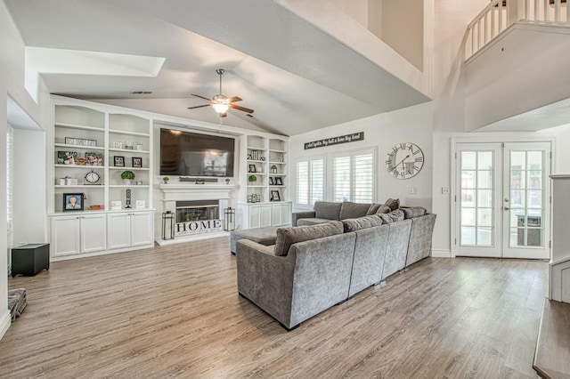 1039 N Burgan Ave, Clovis, CA 93611 - living room with ceiling fan, lofted ceiling, light wood finished floors, a glass covered fireplace, and built in shelves