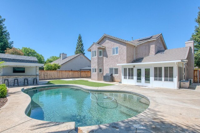 1039 N Burgan Ave, Clovis, CA 93611 - view of swimming pool with french doors, a patio, a fenced backyard, and a sunroom