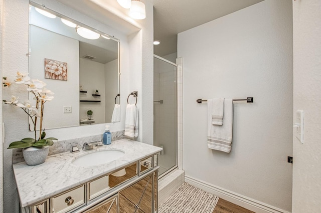 1039 N Burgan Ave, Clovis, CA 93611 - full bath featuring a stall shower, vanity, baseboards, and wood finished floors