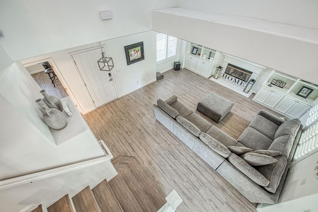 1039 N Burgan Ave, Clovis, CA 93611 - living room featuring wood finished floors, baseboards, and a glass covered fireplace