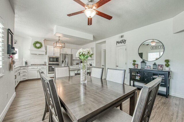 1039 N Burgan Ave, Clovis, CA 93611 - dining space with ceiling fan, light wood-type flooring, baseboards, and a chandelier