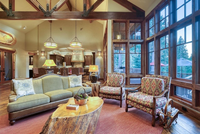 39516 Littleridge Rd, Shaver Lake, CA 93664 - living area with high vaulted ceiling, beamed ceiling, plenty of natural light, wood finished floors, and ceiling fan