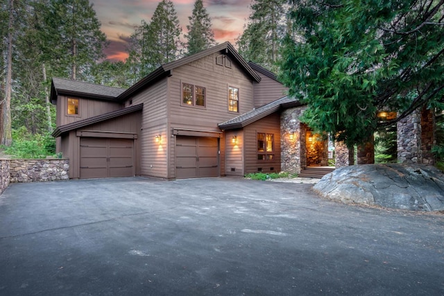 39516 Littleridge Rd, Shaver Lake, CA 93664 - view of front of home featuring asphalt driveway, stone siding, and an attached garage