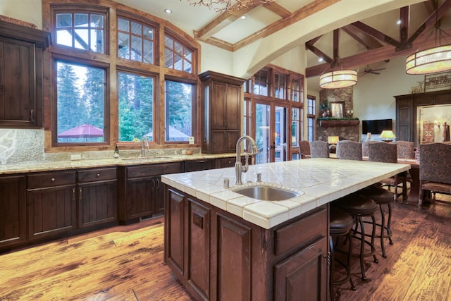 39516 Littleridge Rd, Shaver Lake, CA 93664 - kitchen with a sink, beamed ceiling, light wood-style flooring, dark brown cabinets, and a towering ceiling