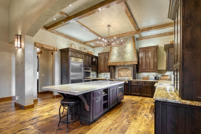 39516 Littleridge Rd, Shaver Lake, CA 93664 - kitchen with stainless steel appliances, custom range hood, decorative backsplash, a chandelier, and coffered ceiling