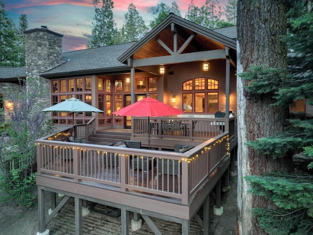 39516 Littleridge Rd, Shaver Lake, CA 93664 - back of house at dusk with roof with shingles, a chimney, and a deck