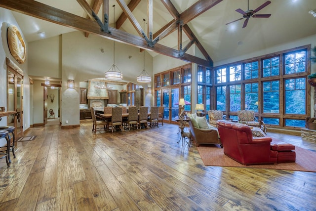 39516 Littleridge Rd, Shaver Lake, CA 93664 - living area with high vaulted ceiling, hardwood / wood-style flooring, a ceiling fan, beam ceiling, and baseboards