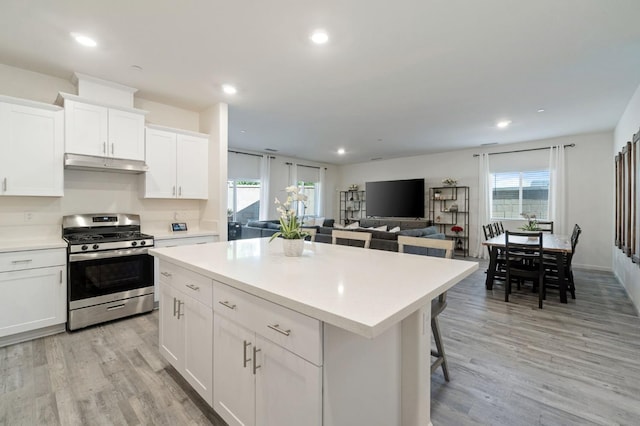 987 S Filbert Ave, Fresno, CA 93727 - kitchen featuring gas range, under cabinet range hood, light countertops, plenty of natural light, and recessed lighting