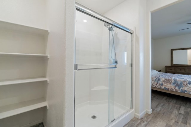 987 S Filbert Ave, Fresno, CA 93727 - full bathroom featuring a stall shower, wood finished floors, and ensuite bath