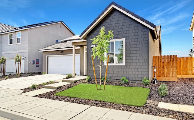 4441 N Phoenix, Fresno, CA 93723 - view of front of house featuring driveway, a garage, and stucco siding