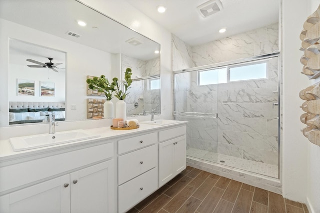 4433 N Phoenix, Fresno, CA 93723 - bathroom with a marble finish shower, double vanity, wood finished floors, recessed lighting, and ceiling fan